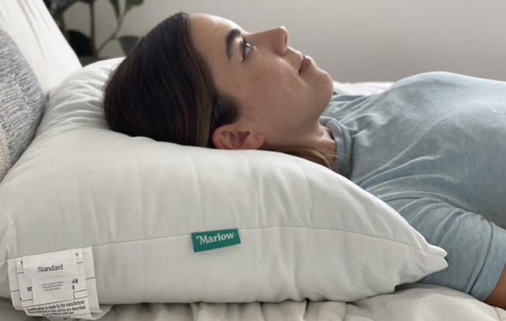 a woman lays on brooklinen marlow pillow