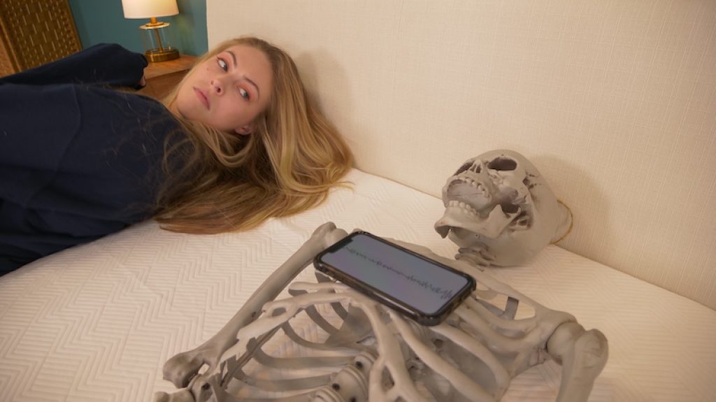 Julia Forbes testing motion transfer on a mattress